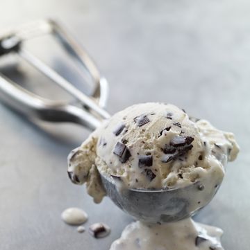 chocolate chip ice cream melting in metal scoop