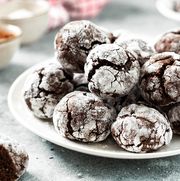 homemade chocolate and coffee crinkle cookies in a white plate on the kitchen table traditional american cookies for christmas with cracks and powdered sugar on a culinary background shutterstock id 2141499079 purchaseorder woman's day job december 2022 client wdy120122sunday other roni martin chance2141499079