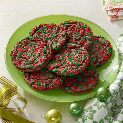 chocolate cake mix cookies with green and red sprinkles on green plate