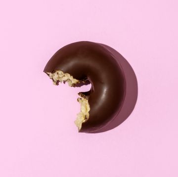 chocolate doughnut on pink colored background