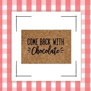 door mat and hot chocolate bomb on red and white gingham background  chocolate gifts