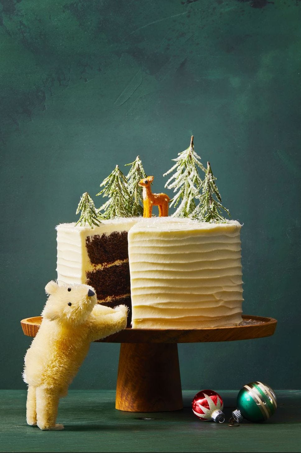 chocolate gingerbread cake with white chocolate buttercream and holiday decorations on top