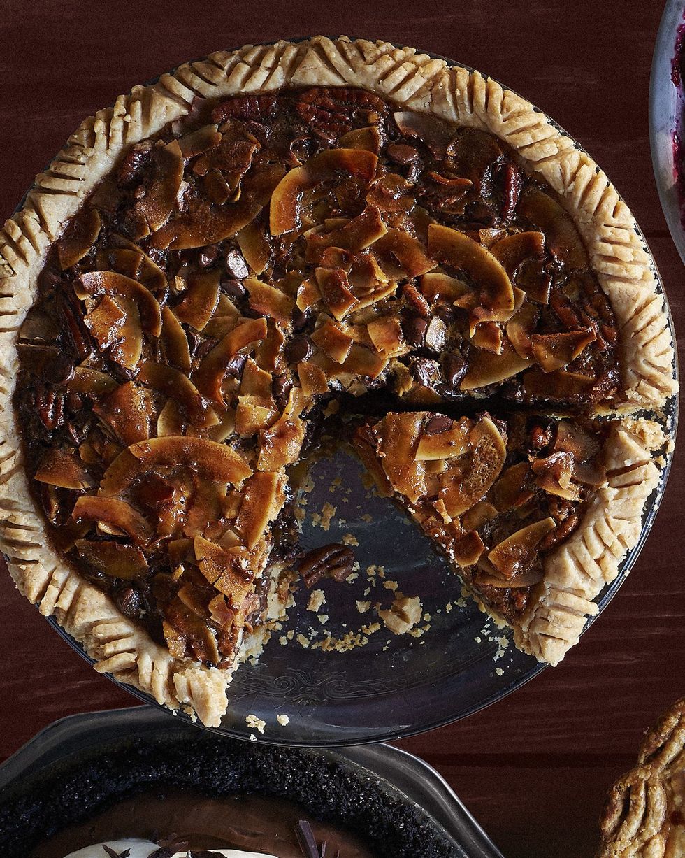 chocolate coconut pecan pie in a metal pie plate with a slice removed