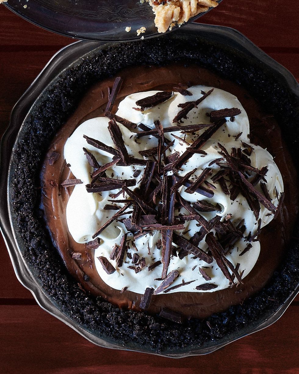 mocha chocolate cream pie in a metal pie plate with whipped cream and shaved chocolate on top
