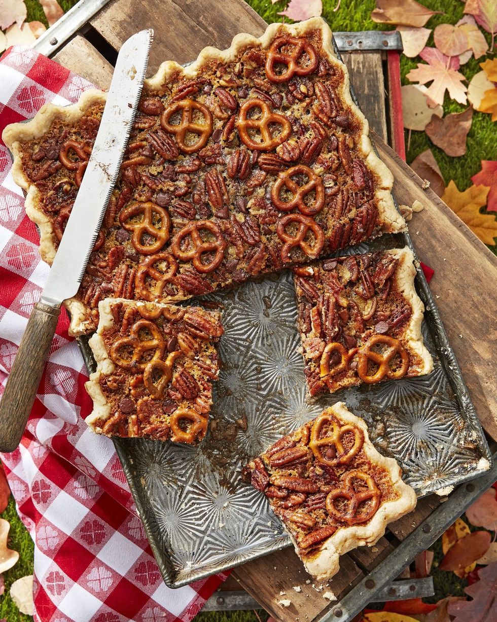 pretzel chocolate pecan slab pie in a rectangle pan with pieces cut into squares