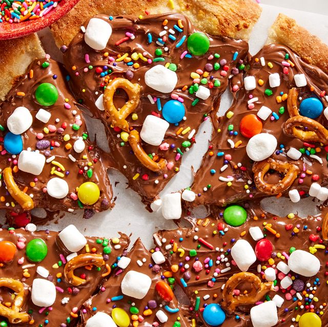 chocolate covered pizza dough topped with marshmallows, pretzels, and candy