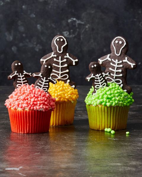 colorful cupcakes with skeleton cookies on top
