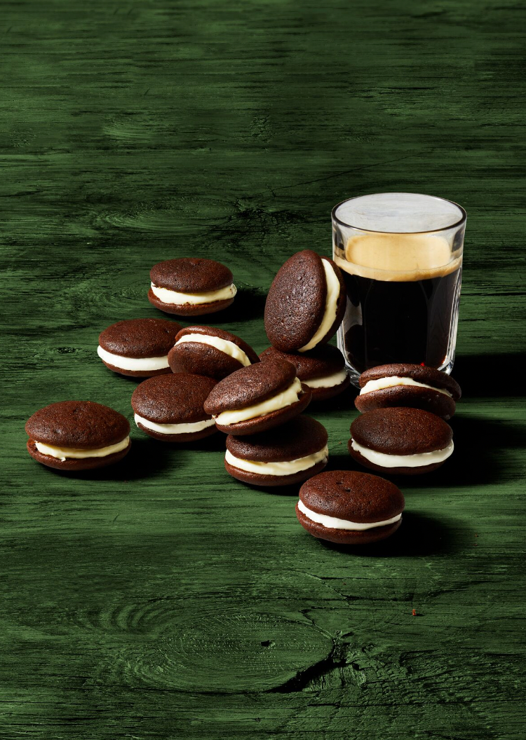 chocolate whoopie pies next to a glass of dark beer