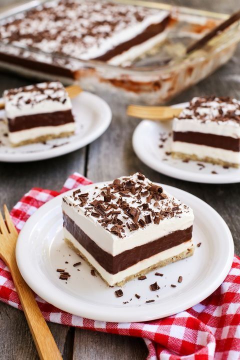 layered chocolate pudding dessert slice on plate with red checkered napkin