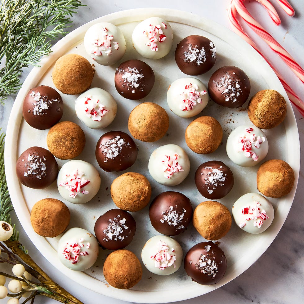 chocolate truffles topped with candy canes, sea salt, and cocoa powder