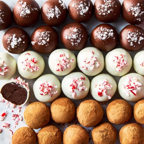 chocolate truffles topped with candy canes, sea salt, and cocoa powder