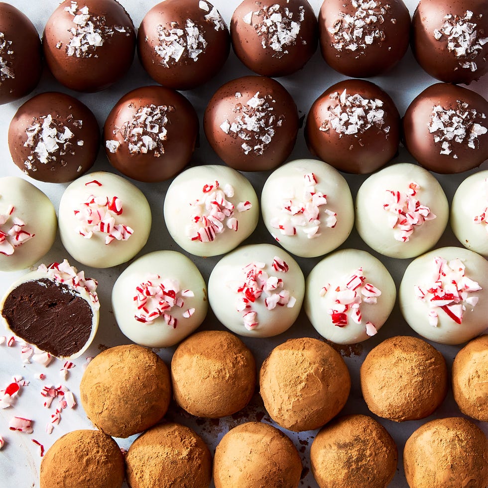 chocolate truffles topped with candy canes, sea salt, and cocoa powder