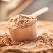 chocolate whey protein powder with a filled scoop