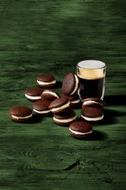 chocolate whoopie pies next to a glass of dark irish beer