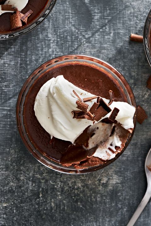 chocolate pots de creme topped with whipped cream and chocolate shavings