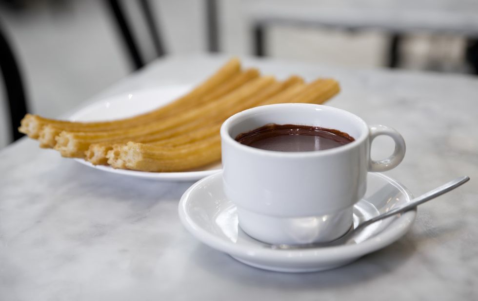 churros with a cup of warm dipping chocolate