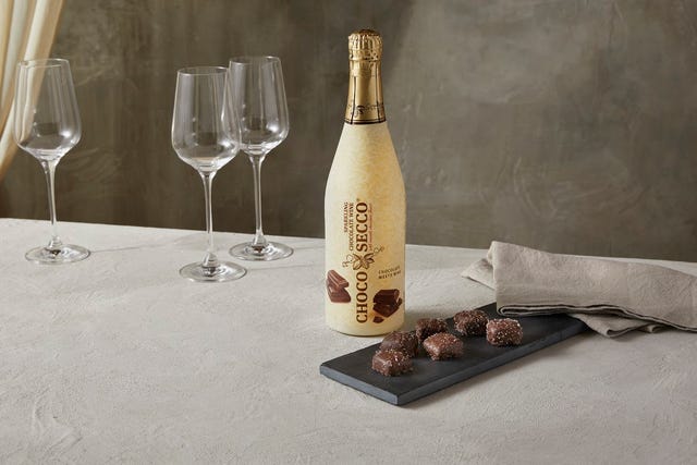 aldi chocolate prosecco, chocosecco bottle next to plate of chocolates