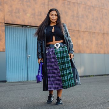 paris, france september 30 model paloma elsesser wears a black trench coat, black croptop, green and purple plaid print skirt, blue bag, and black adidas sneakers at the coperni show on september 30, 2021 in paris, france photo by melodie jenggetty images