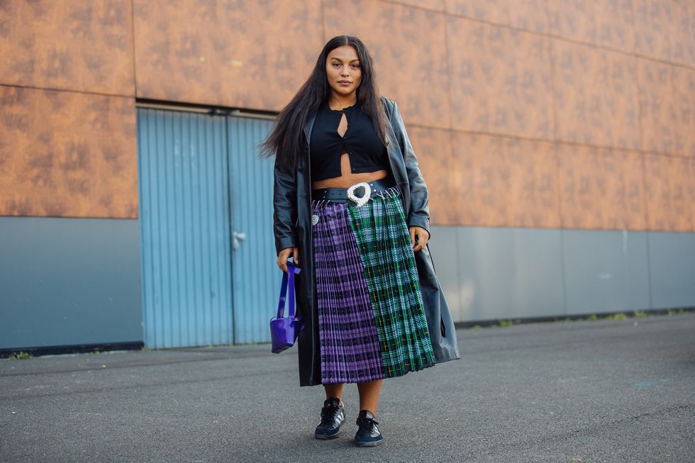 paris, france september 30 model paloma elsesser wears a black trench coat, black croptop, green and purple plaid print skirt, blue bag, and black adidas sneakers at the coperni show on september 30, 2021 in paris, france photo by melodie jenggetty images