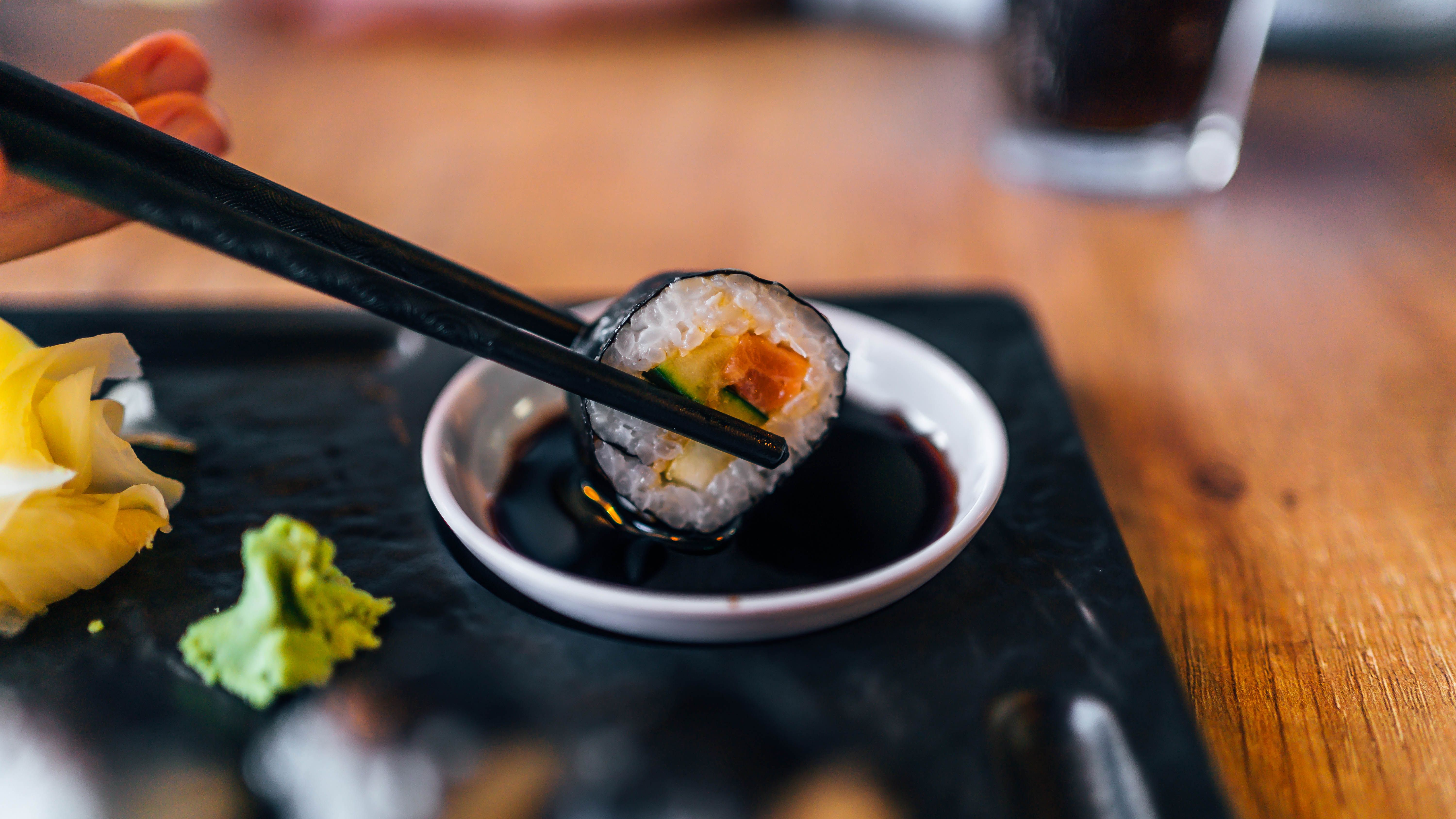 https://hips.hearstapps.com/hmg-prod/images/chopstick-with-sushi-roll-and-soy-sauce-royalty-free-image-1684345304.jpg?crop=1xw:0.84375xh;center,top