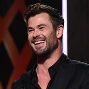 chris hemsworth holding award on stage