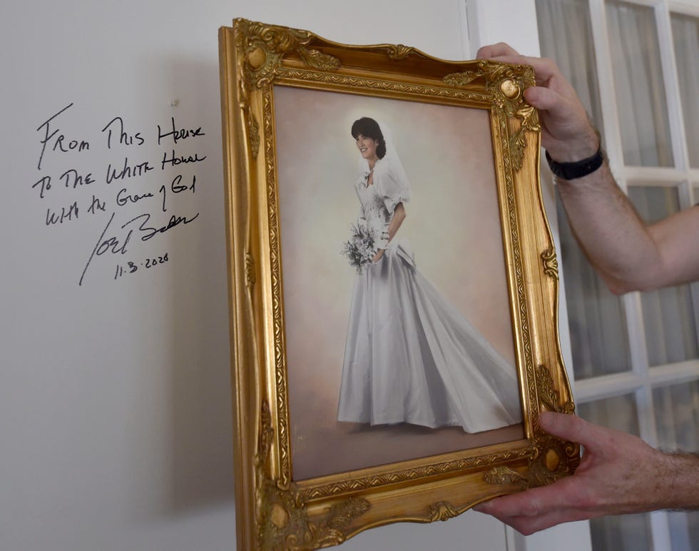 chris kearns removes a wedding photo from his families
