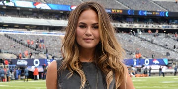 Chrissy Teigen's boobs pop out of skintight catsuit as she