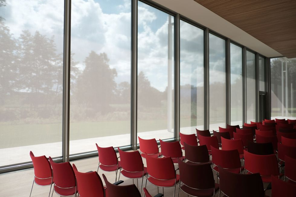 Red, Interior design, Architecture, Room, Window, Building, Conference hall, Window covering, Chair, Shade, 