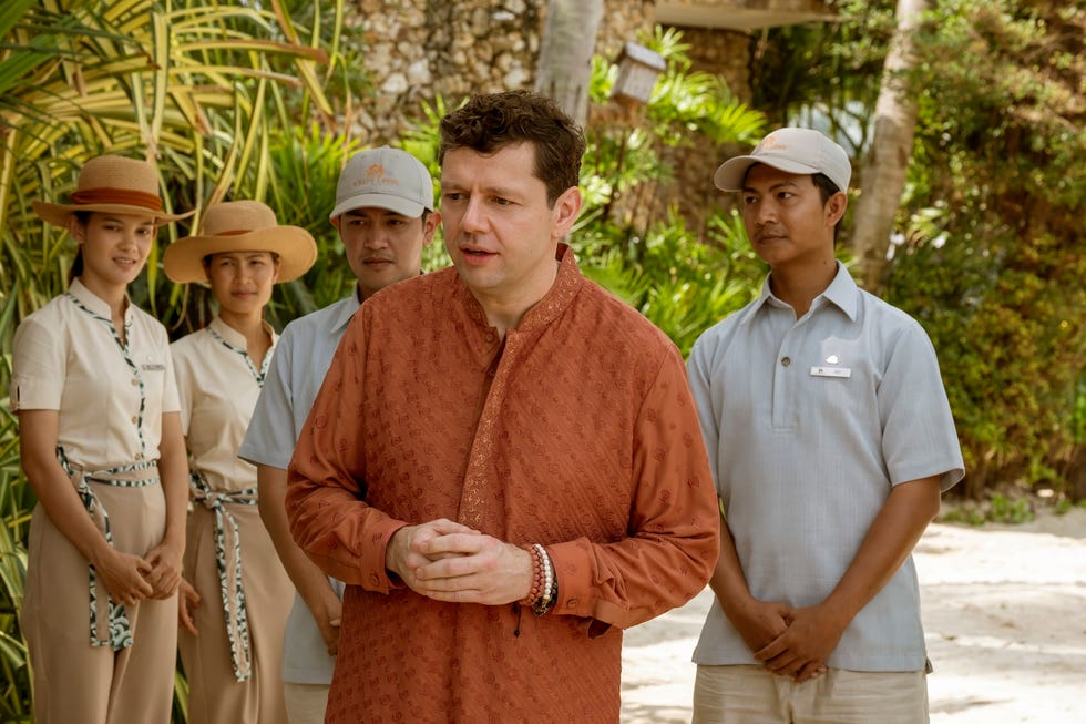 a gathering of staff members in a tropical setting