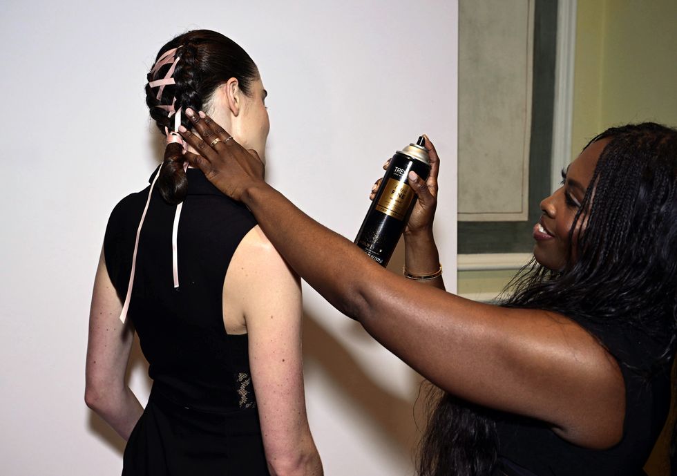 new york, new york september 08 tresemme lead hairstylist lacy redway prepares a model backstage with tresemme ultra fine mist hairspray during tresemme x christian siriano during nyfw on september 08, 2023 in new york city photo by dave kotinskygetty images for tresemme