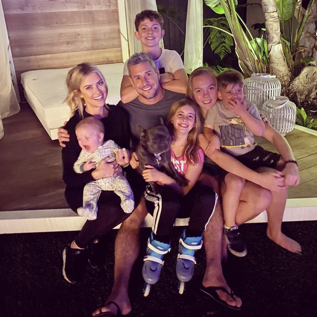 family photo of christina and ant anstead with their shared seven children and french bulldog