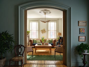 a living room with a couch and chairs