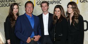 arnold schwarzenegger surrounded by his ex wife and three of their children for a red carpet photo