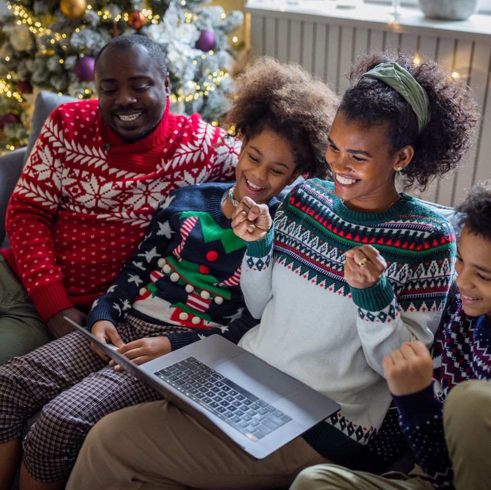 family looking at laptop on christmas
