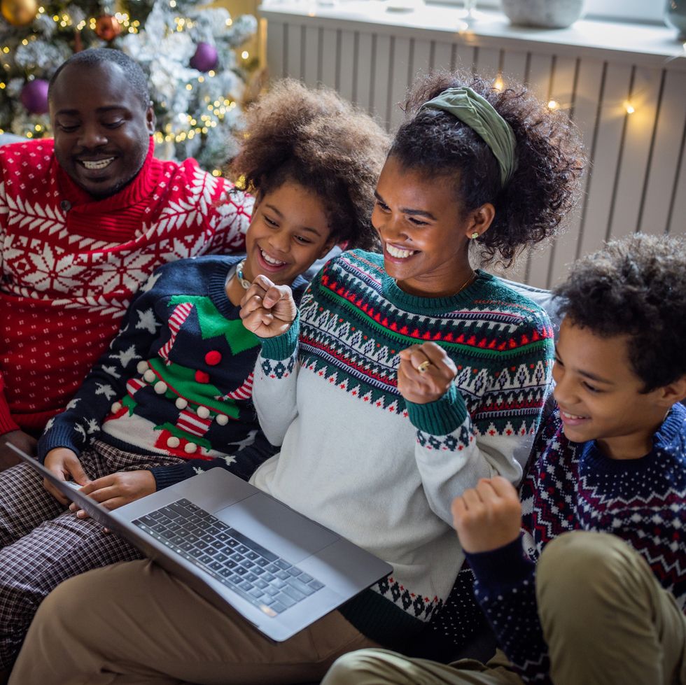 family looking at laptop on christmas
