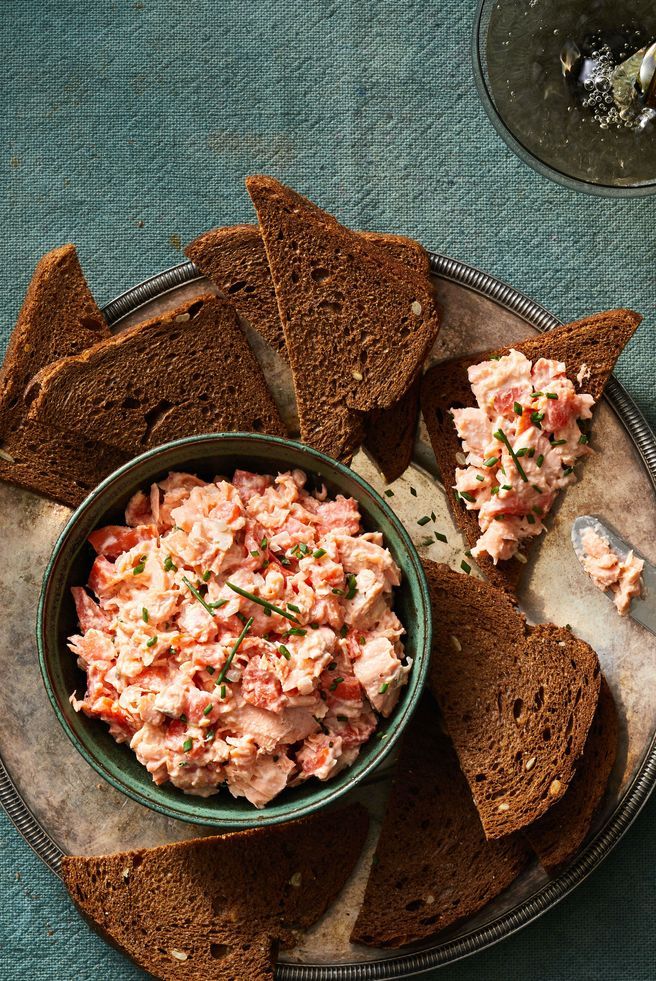 a bowl of salmon rillette with slices of rye bread