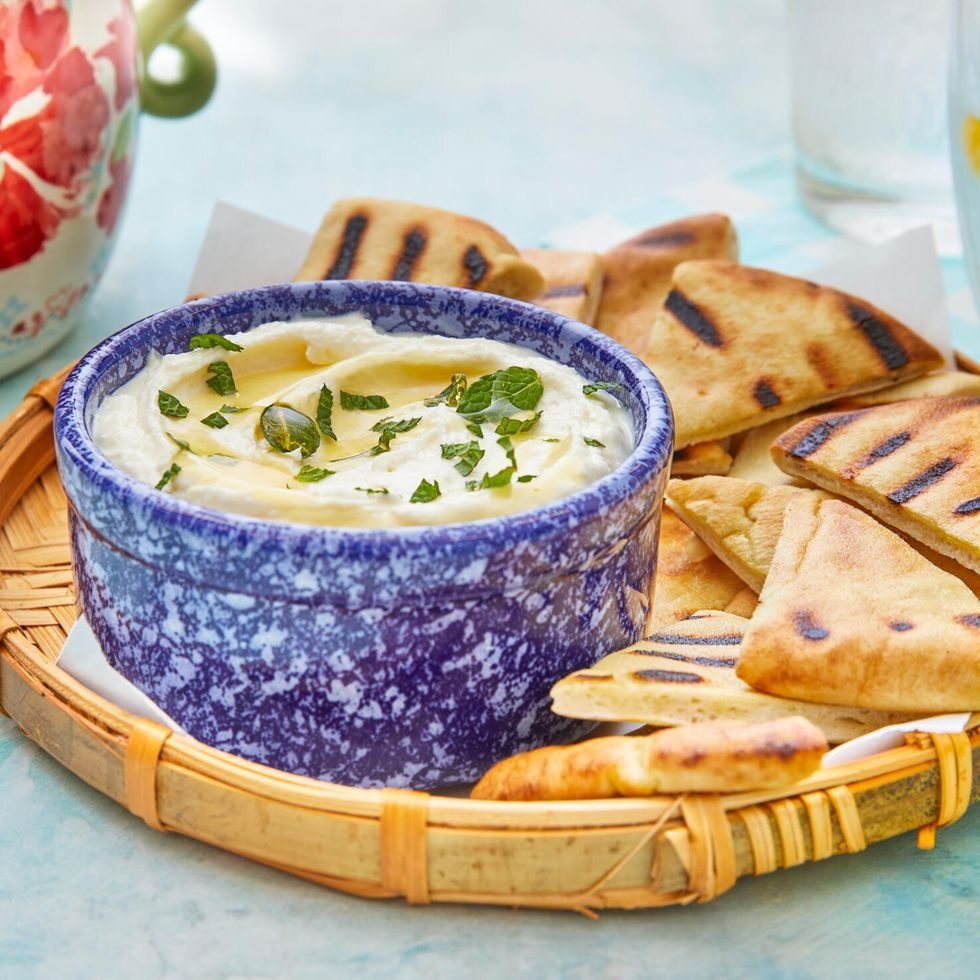 whipped feta dip in blue bowl with pita