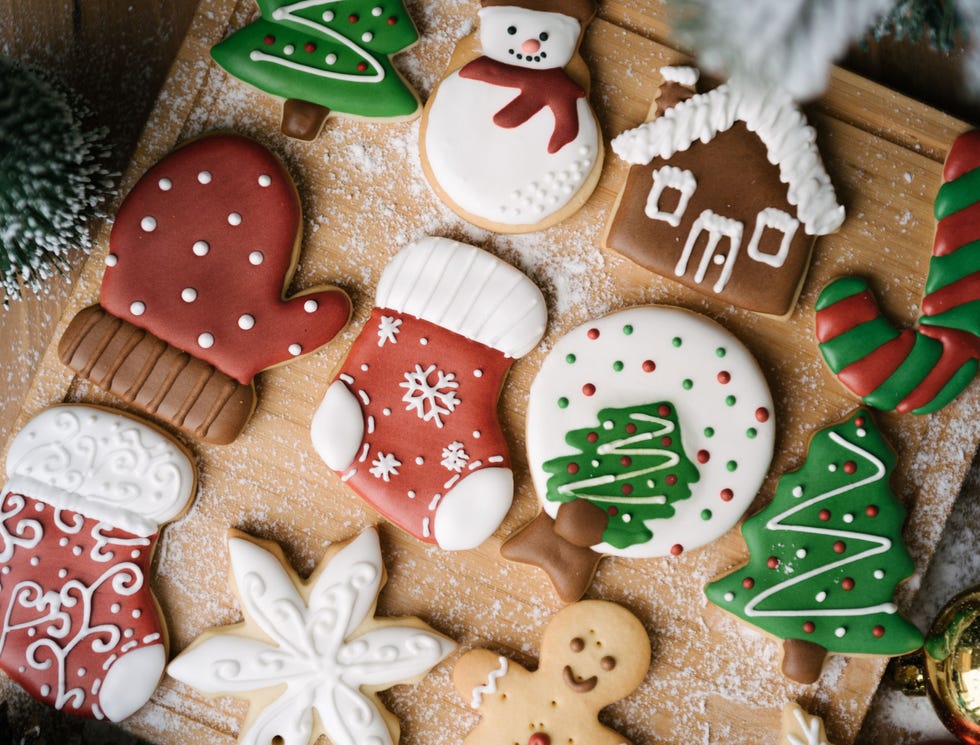 Christmas biscuits on a wooden board decorated with icing and Christmas motifs