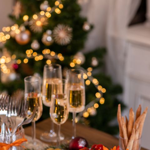 christmas brunch buffet spread with antipasti and champagne in festive rustic kitchen