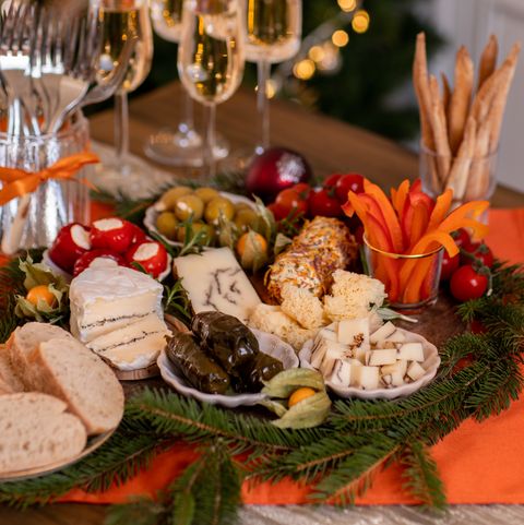 christmas brunch buffet spread with antipasti and champagne in festive rustic kitchen