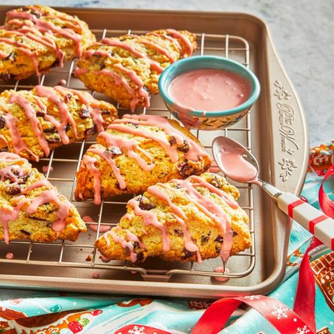 cranberry scones with pink glaze on baking sheet