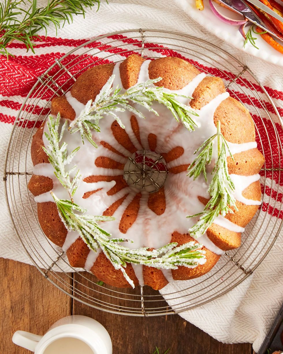 rosemary lemon bundt cake with vanilla glaze and candied rosemary on top