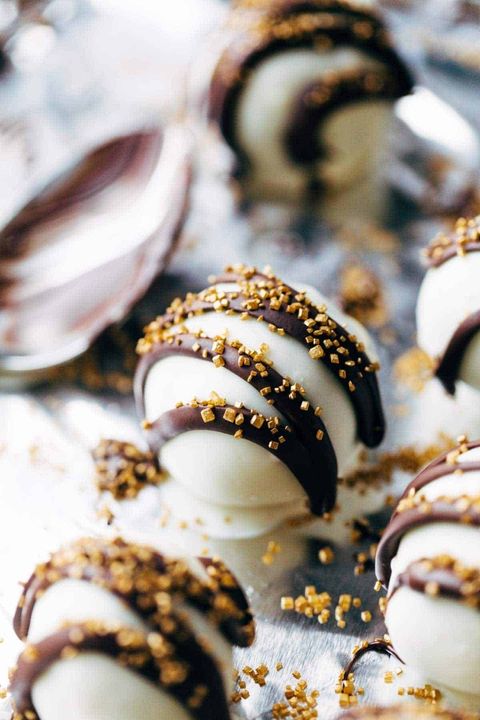 minty chocolate holiday cake bites with gold sprinkles on foil