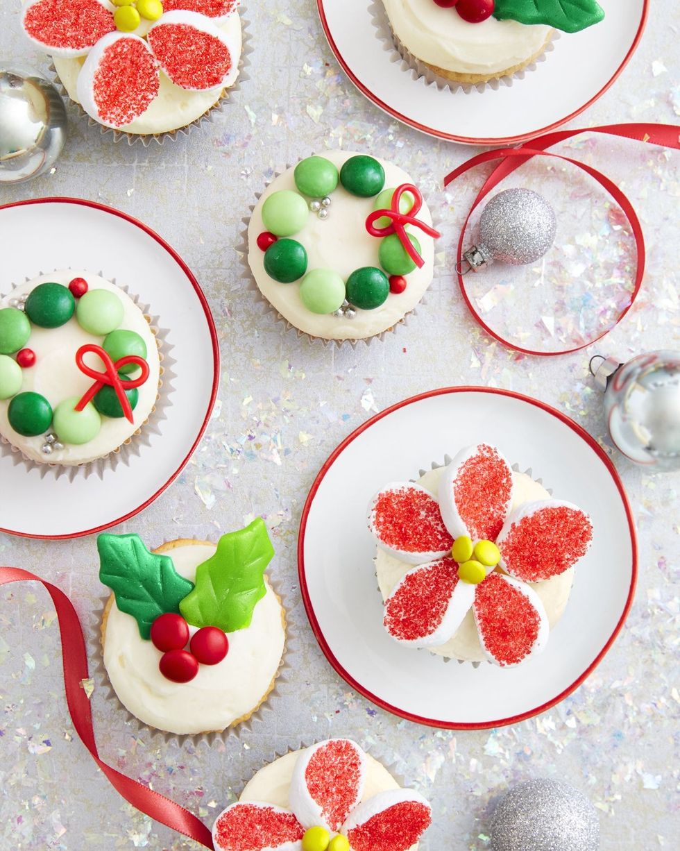 christmas cupcakes decorated with candy to look like wreaths holly and poinsettias