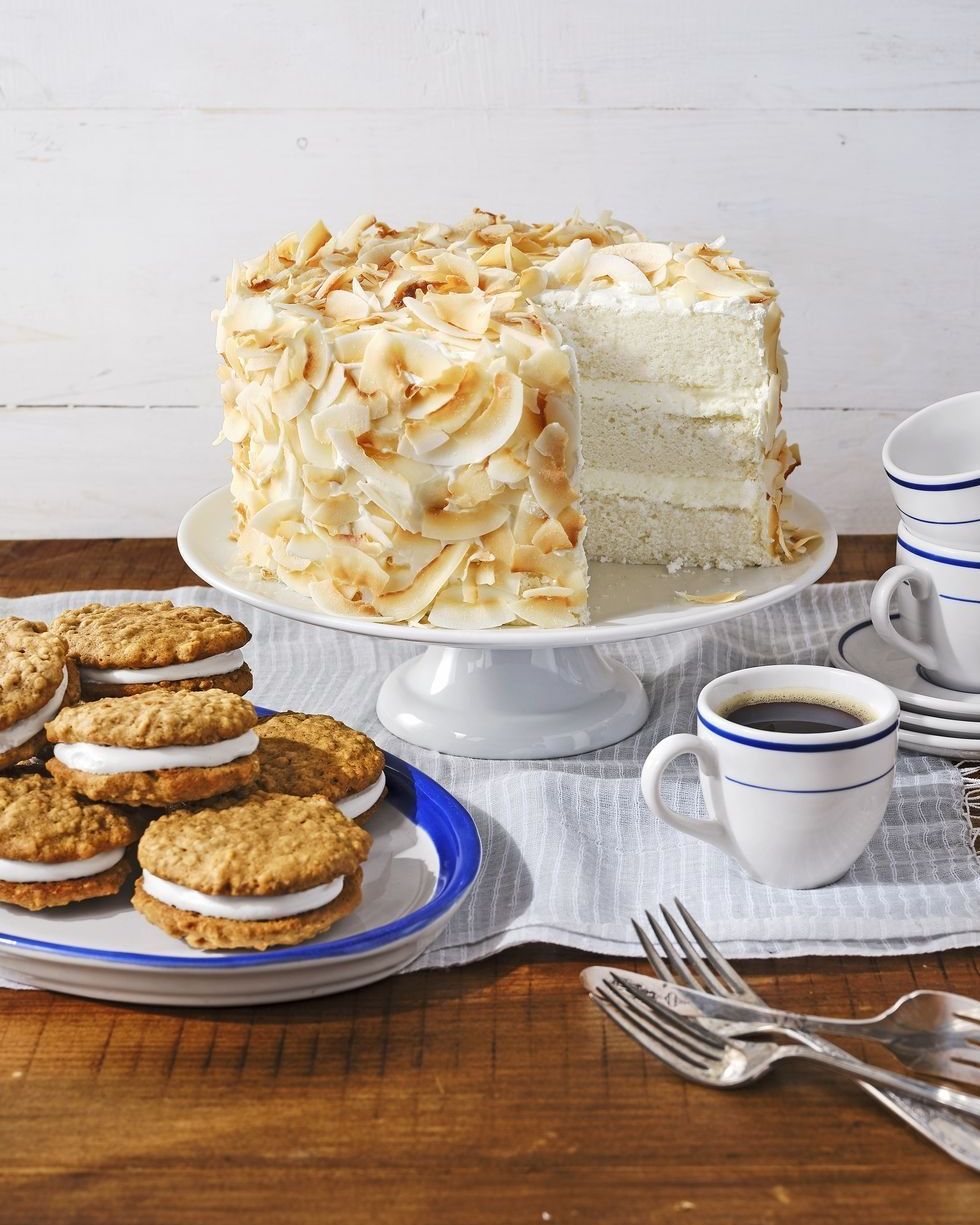 three layer coconut angel cake on a white cake stand