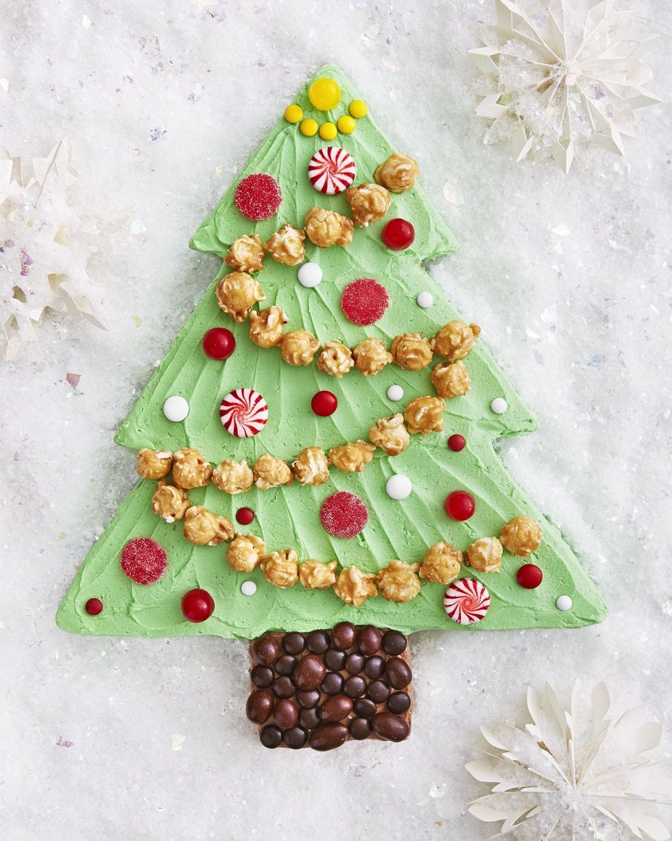 christmas tree sheet cake decorated with caramel corn garland and various candies as ornaments
