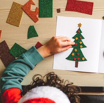 child writing christmas card messages