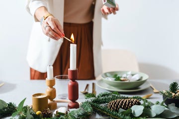 christmas celebration an anonymous woman setting up christmas dinner table