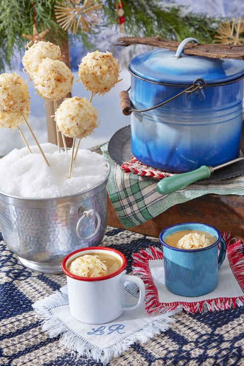 two mugs of hot buttered rum each with a coconut ice cream ball
