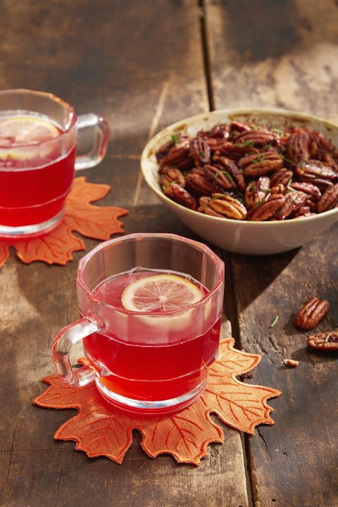 cranberry mulled white wine in glass mugs with a slice of lemon